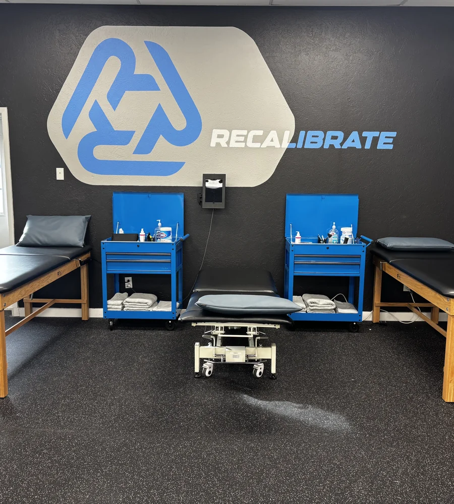 Treatment tables in the hands-on treatment area at Recalibrate Performance and Rehab in College Station, TX
