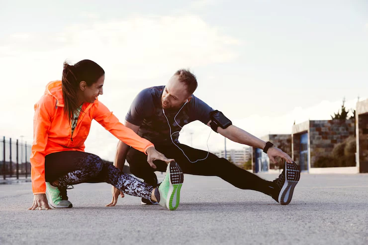portrait-two-people-stretching-outdoors_23-2147839308
